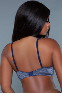 Model wearing blue bra facing backwards showing back straps and clasps of bra