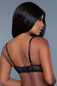 Model showing her back and the black bra