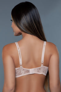 Model facing the back showing straps and back band of the beige bra