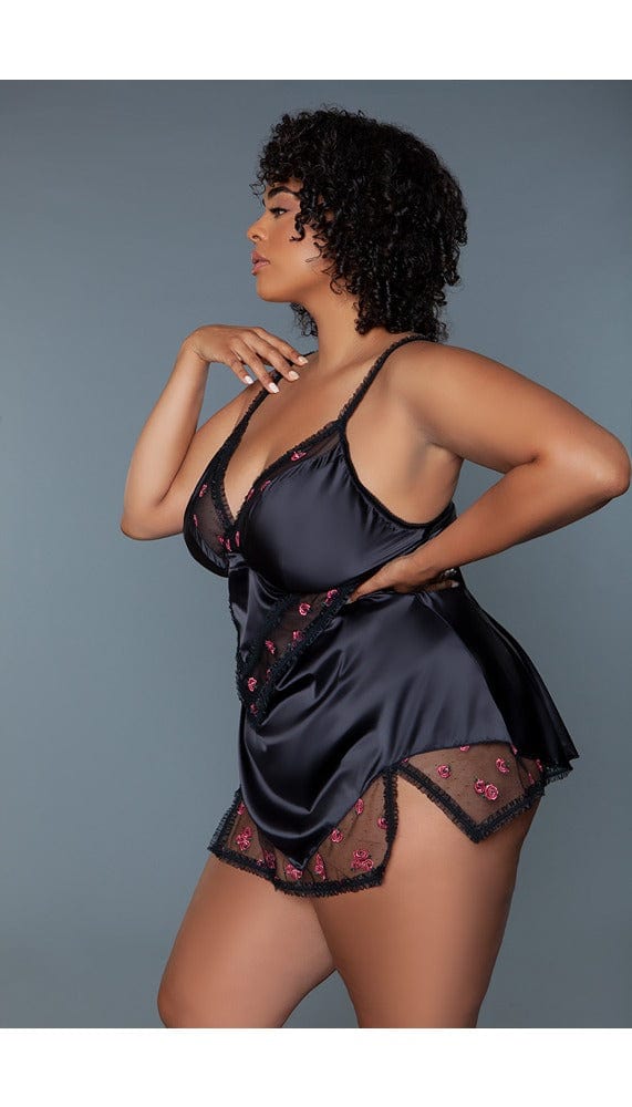 Side view of black satin babydoll dress with thin sheer ruffle trim.