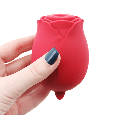 Image of hand holding the rose vibrator.