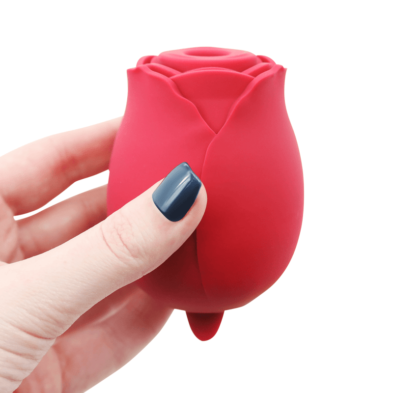 Image of hand holding the rose vibrator.