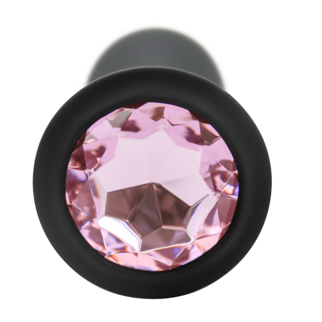 Close-up image of the pink jewel at the base of the anal plug.