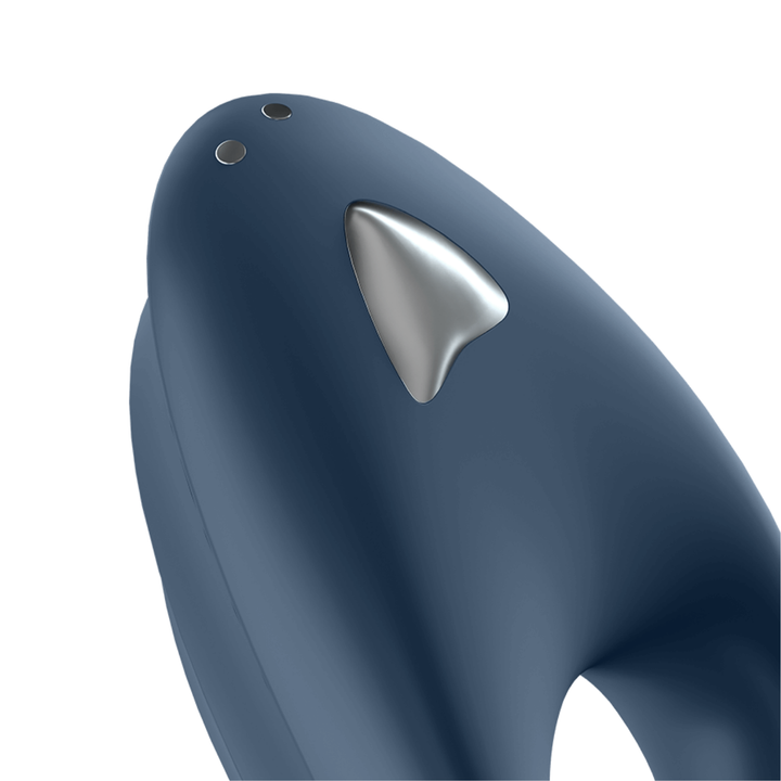 Close-up image of the ring vibrator, showing the on and off button as well as the magnetic charging connector.