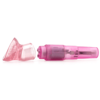 Image of the clit stimulator on its side behind one of the attachments.