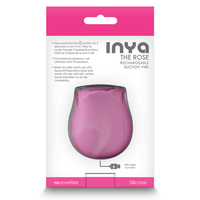 Image of the back of the product packaging. Packaging reads: INYA. The rose. Rechargeable suction vibe. Press and hold the button for 2 seconds to turn it on. Press to cycle through 7 speeds/functions. Hold for 2 seconds to turn off. For maximum pleasure, use lubricant with this product. Wash toy after each use with the liquid anti-bacterial soap and water. Pat dry with soft, cotton towel and allow to air dry completely. USB cable included. NS Novelties. Silicone.
