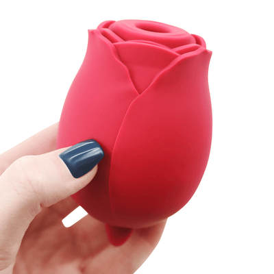 Another image of a hand holding the rose vibrator.