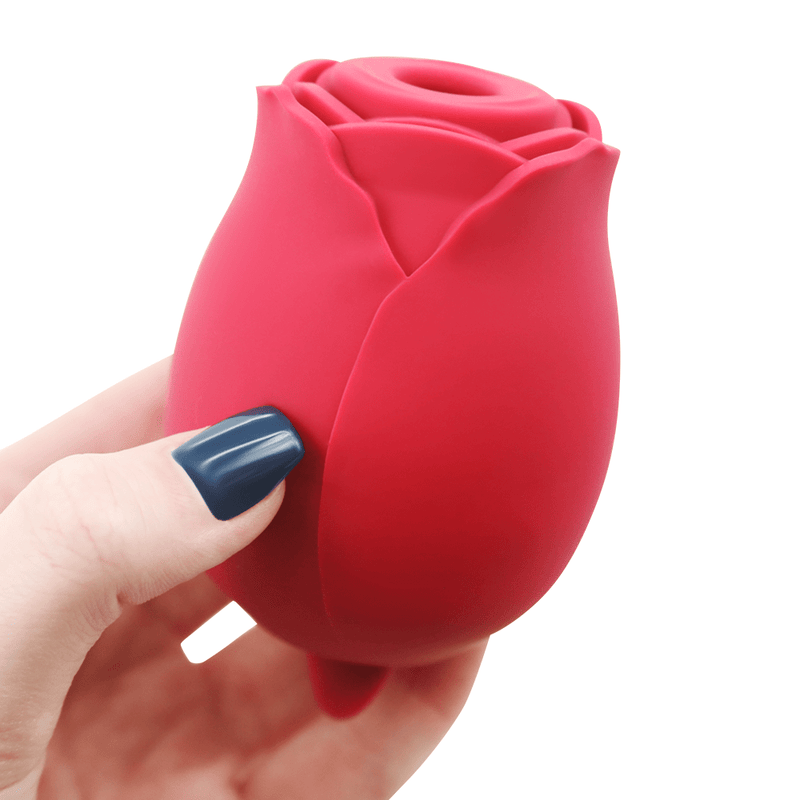 Another image of a hand holding the rose vibrator.