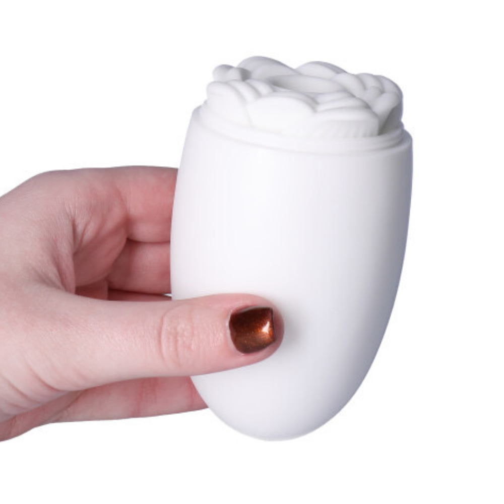 Picture of the rose masturbator with the case being held in hand.