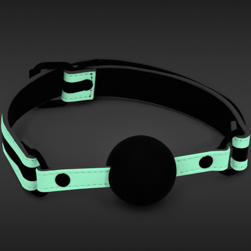 Image of the Glow In The Dark Bondage Ball Gag shown with the faux leather strap glowing in the dark.
