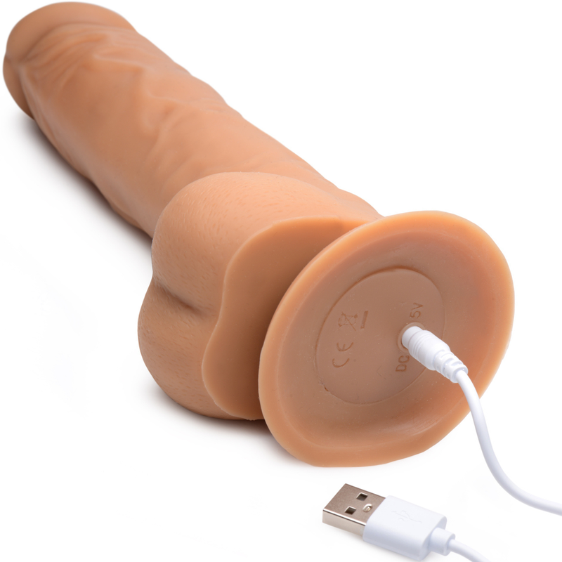 Image of the Power Pounder Realistic Thrusting Silicone Dildo With Suction Base being charged. Charging port is located at the bottom of the suction cup base.