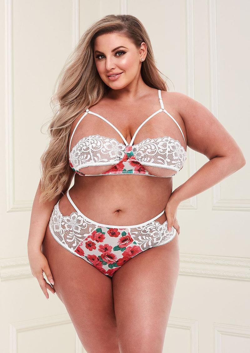 Image of the White Floral & Lace Cutout Lingerie Set on a plus size model. This plus size lingerie set is available in three sizes and includes a strappy bralette and high waisted panty with sexy cutouts.