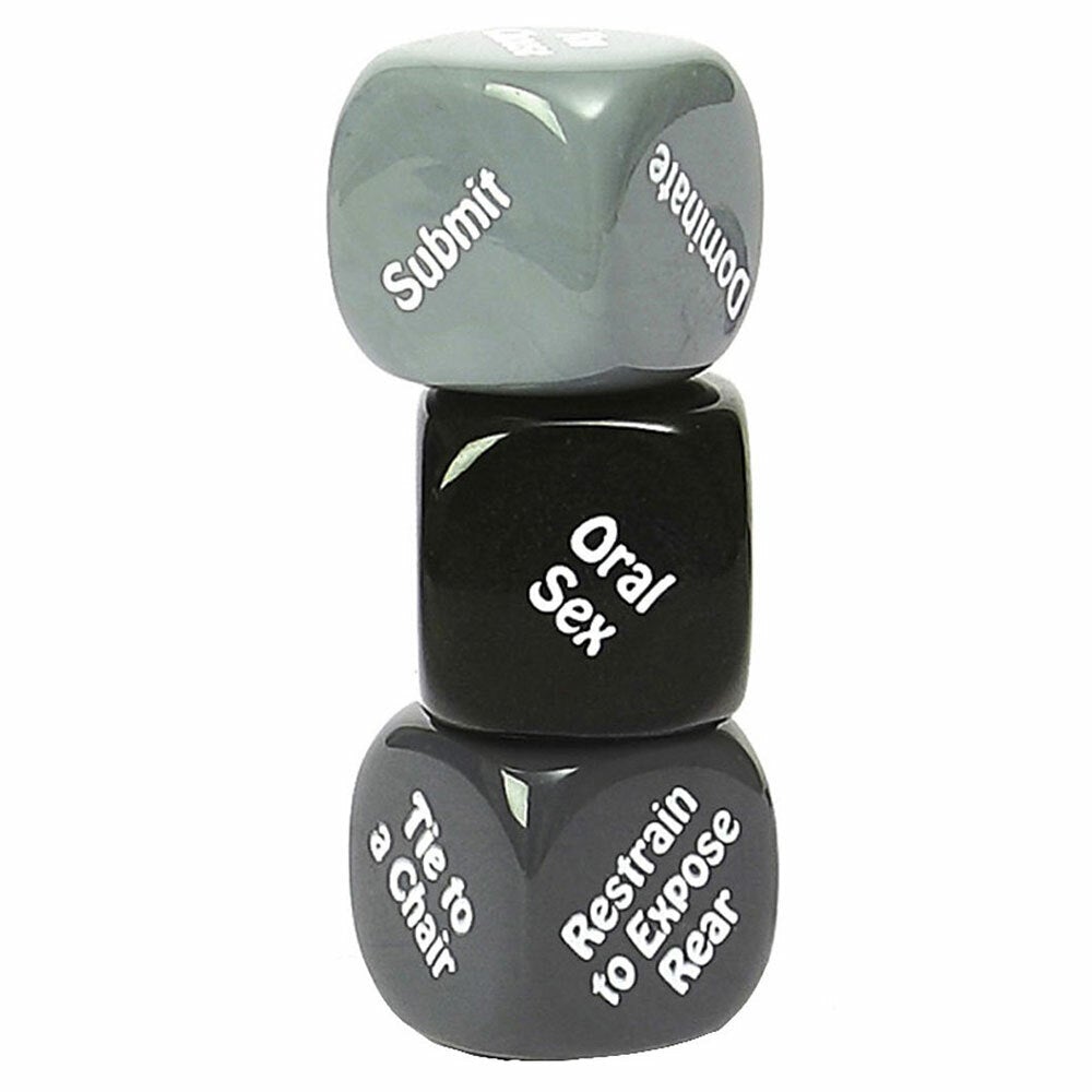 Close up image of the Kinky Nights Bondage Dare Dice set. The first die is to choose Submit or Dominate, the second die chooses how to restrain your partner, and the third die chooses what pleasure or action they'll receive
