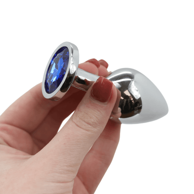 Image of the blue jewel metal butt plug being held in hand. Medium size.