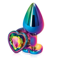 Image of the Rainbow Heart Jeweled Metal Butt Plug. This decorative anal plug has a tapered shape and heart shaped base with a rainbow jewel