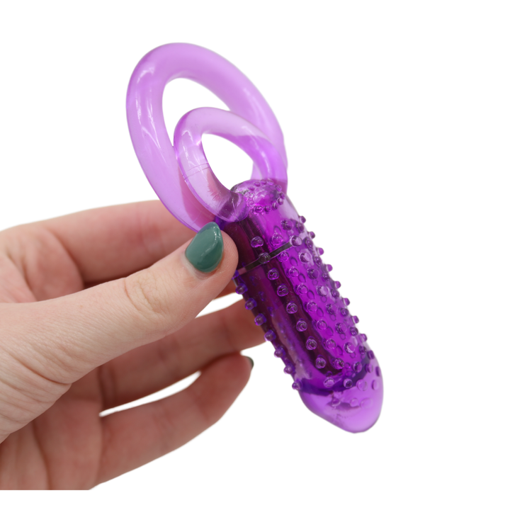Image of hand holding the ring from the side. This ring has nubby ticklers on the bullet for increased stimulating that will drive both couples crazy! Spice things up for both you and your partner with this vibrating cock ring that will stimulate you both at the same time!