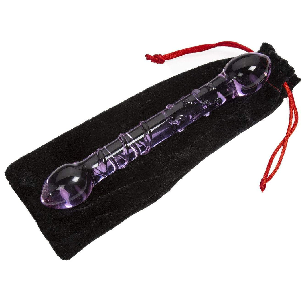 Image of purple glass dildo on top of velvet black bag