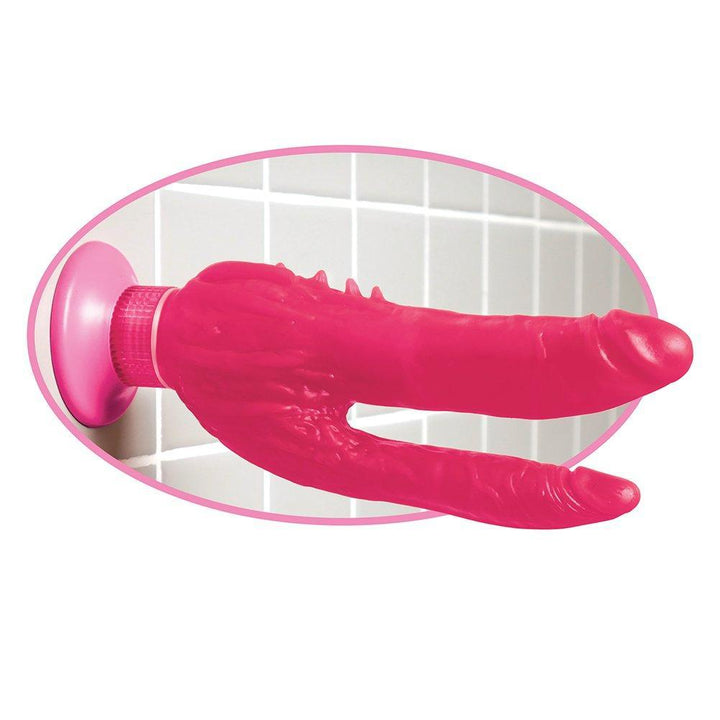 Double penetration suction cup dildo shown on bathroom wall