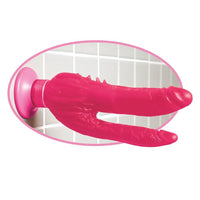 Double penetration suction cup dildo shown on bathroom wall
