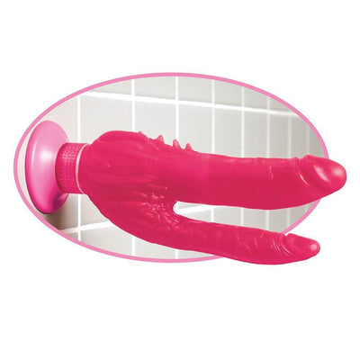 Double penetration suction cup dildo shown on bathroom wall