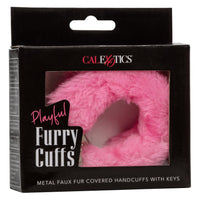 Image of the packaging for the Playful Furry Cuffs with pink faux fur. Text reads Playful Furry Cuffs, Metal faux fur covered handcuffs with keys