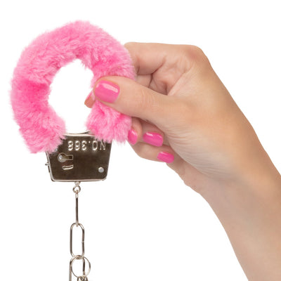 Image of a person's hand holding the Playful Furry Cuffs.