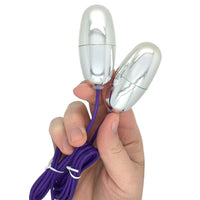 Image of the 2 silver bullets being held.