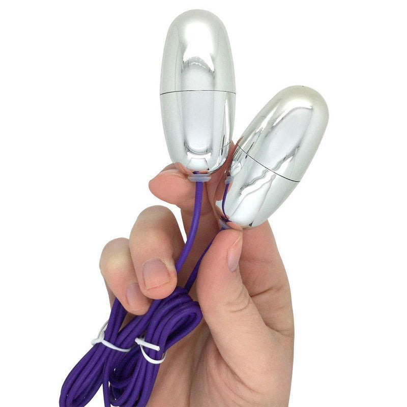 Image of the 2 silver bullets being held.