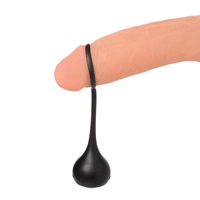 Image displays cock dangler penis strap being demonstrated on a dildo.