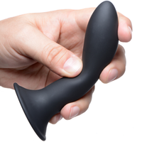 Image of model holding the black Squeeze-It Bendable Silicone Suction Cup Dildo