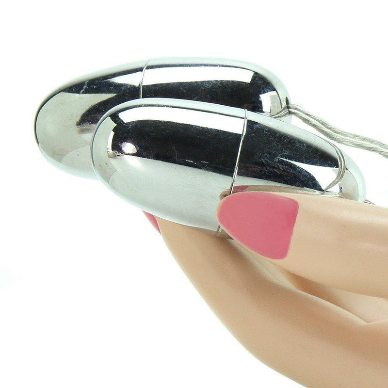 Image of hand holding two vibrating silver bullets